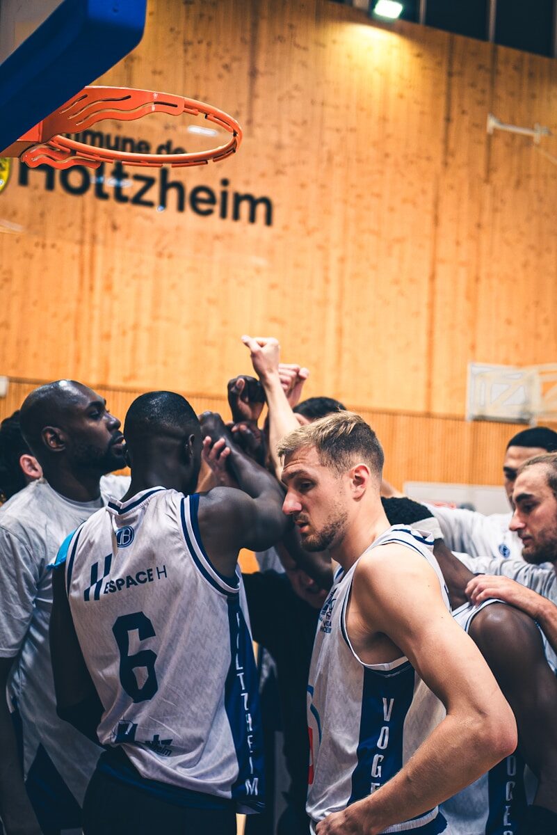 Basketball players huddle together during a game.